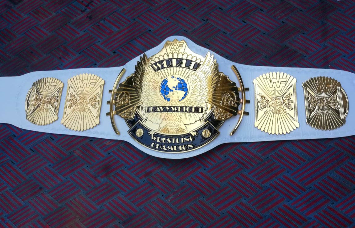 winged eagle championship belt on a dark blue background