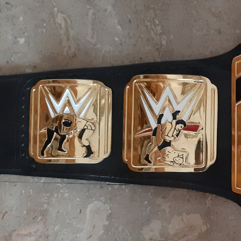 Wrestling championship belt with gold buckle on a textured surface
